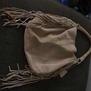 Gray purse by linea Pelli.  Very in with the fringes